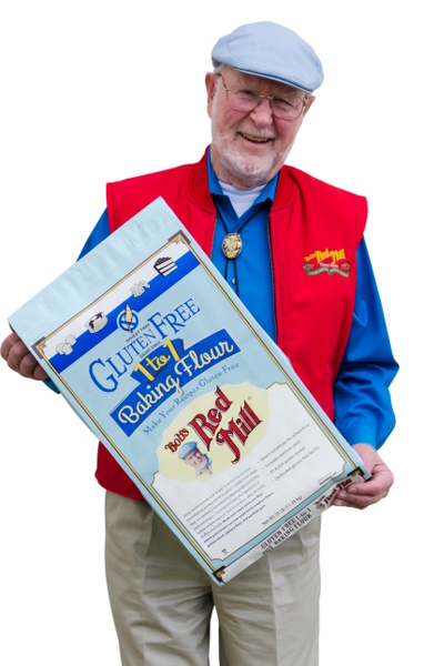 Bob Moore holding a bulk bag of Bob's Red Mill Gluten Free 1-to-1 Baking Flour